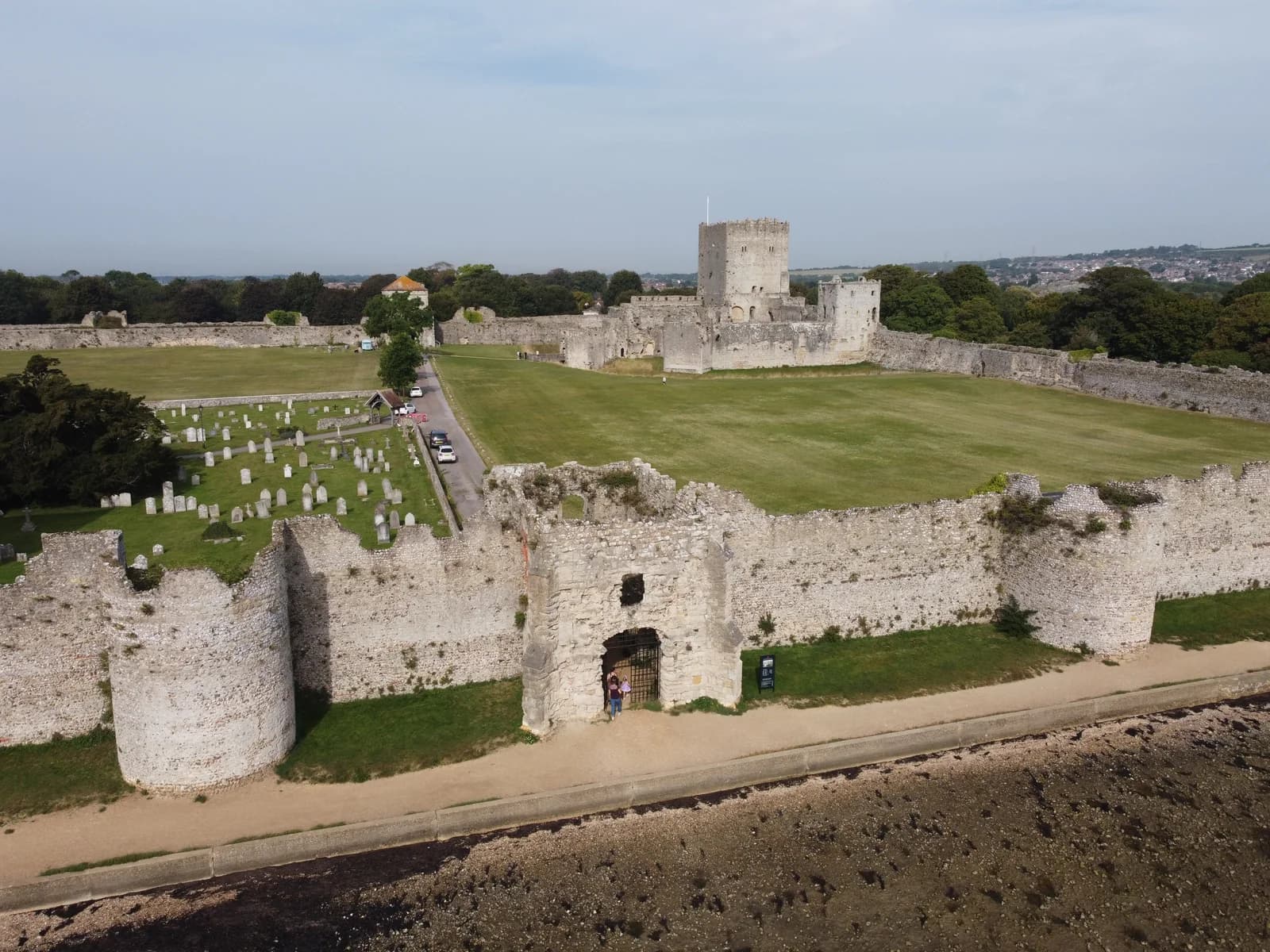 Portchester Castle and its stone walls beside the shore, seen from above